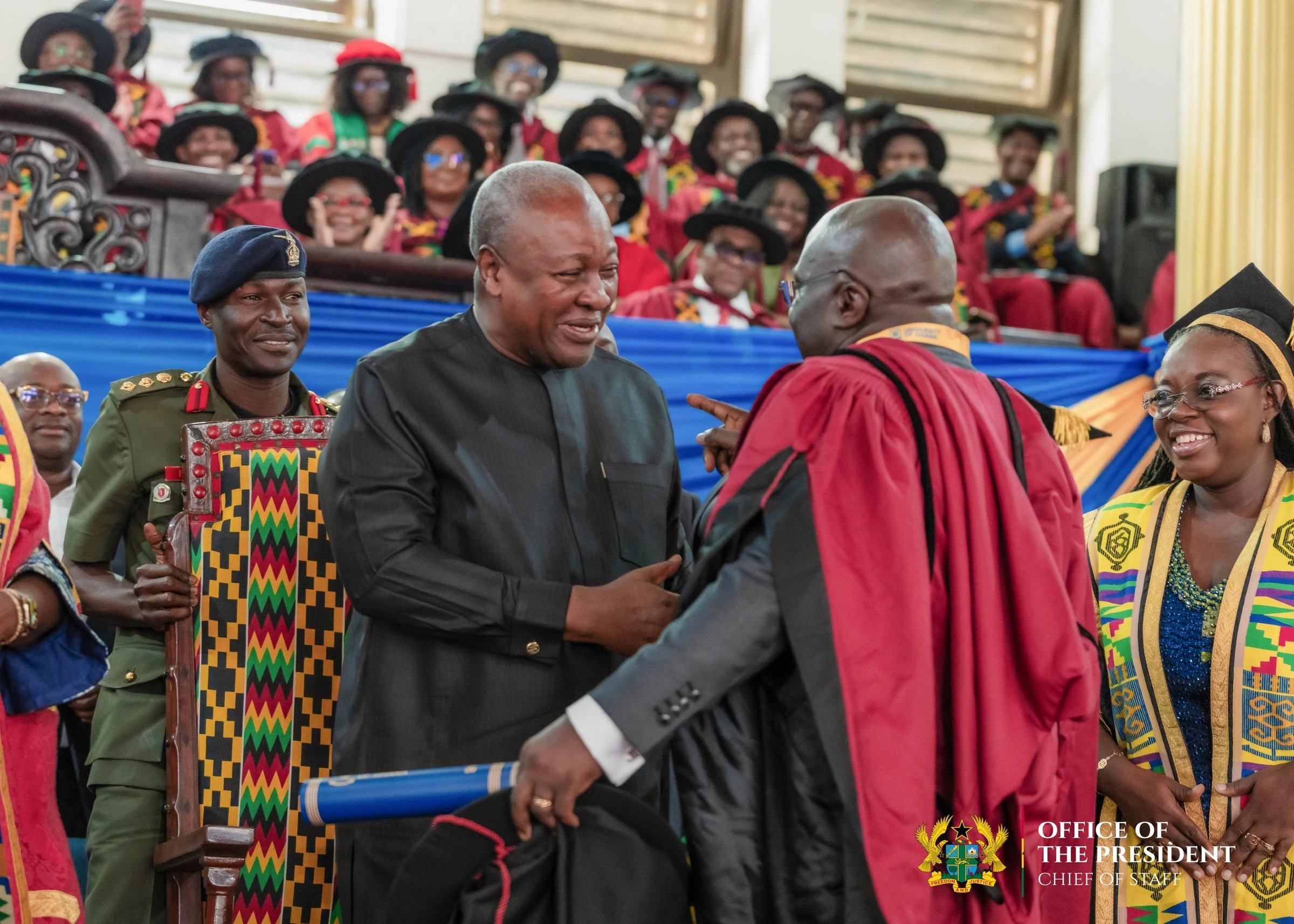 Julius Debrah in doctoral robes greeting President Mahama at the graduation ceremony